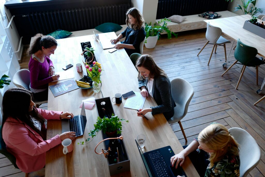 Interpreters and team members collaborate in a shared workspace, preparing translations and strategies for multilingual events.