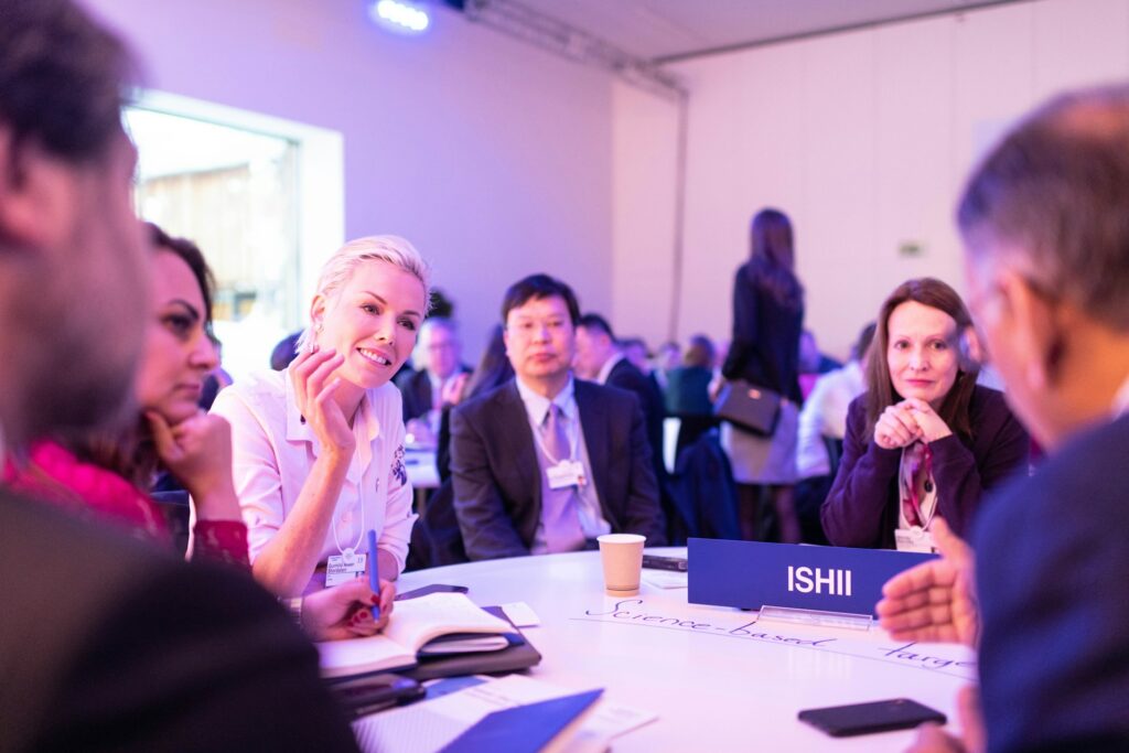 Interpreters support a roundtable discussion at a global conference, ensuring clear communication across multiple languages.