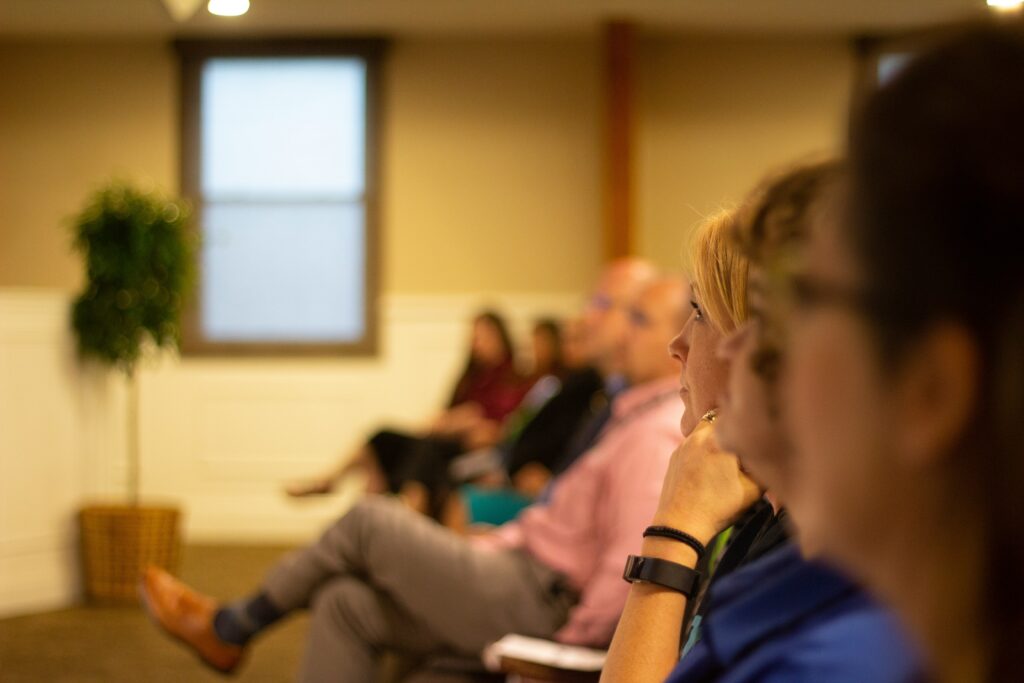 Professionals attentively listening during a multilingual workshop, representing cross-cultural training, language interpretation, and global communication services.